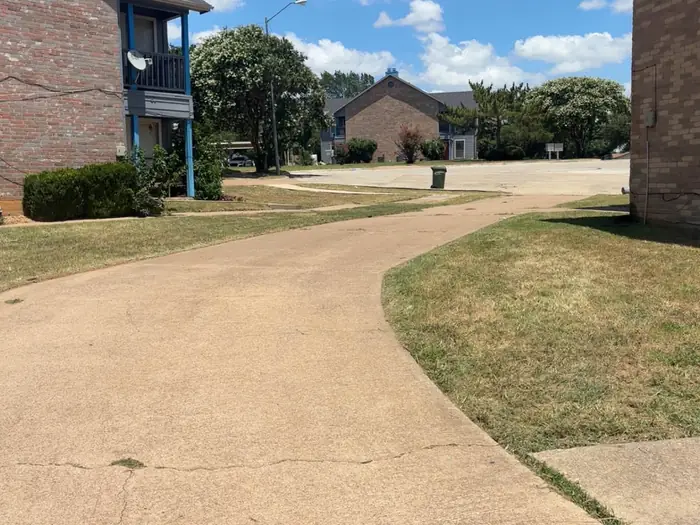 Curved front walkway with the lawn edged tight along the concrete