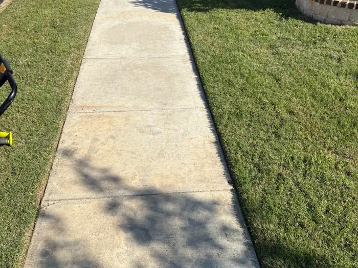 Sidewalk with a crisp cut edge on both sides after edging